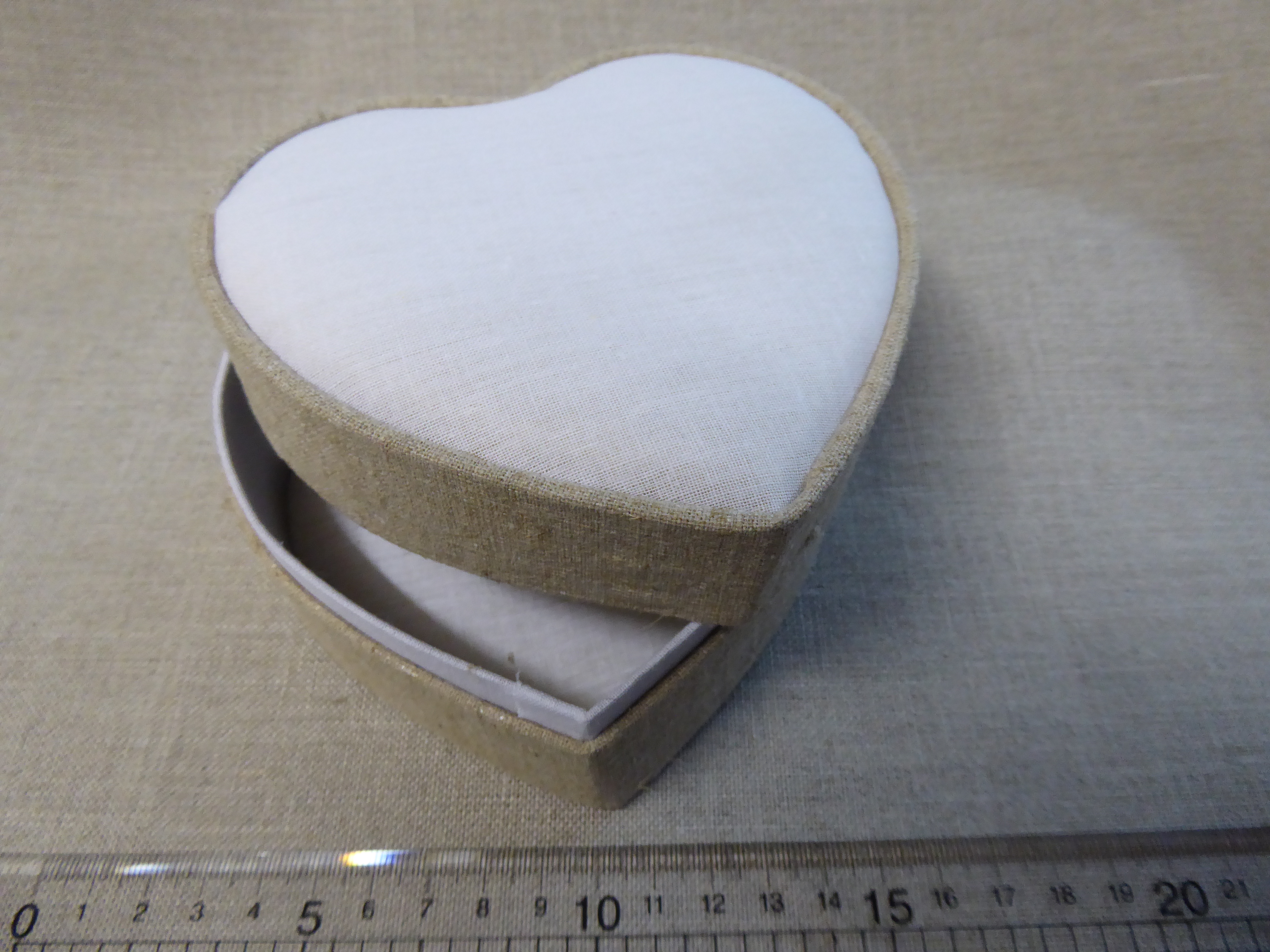 small linen covered box with heart shaped aperture 