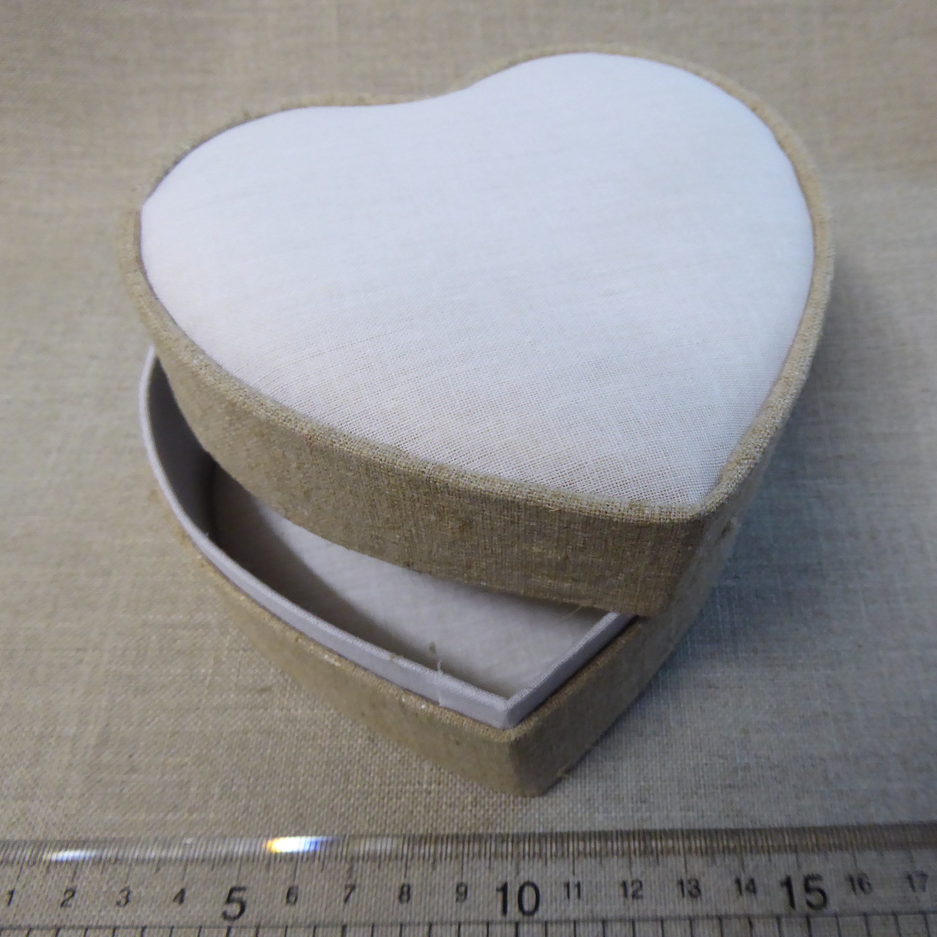 large linen covered box with heart shaped aperture